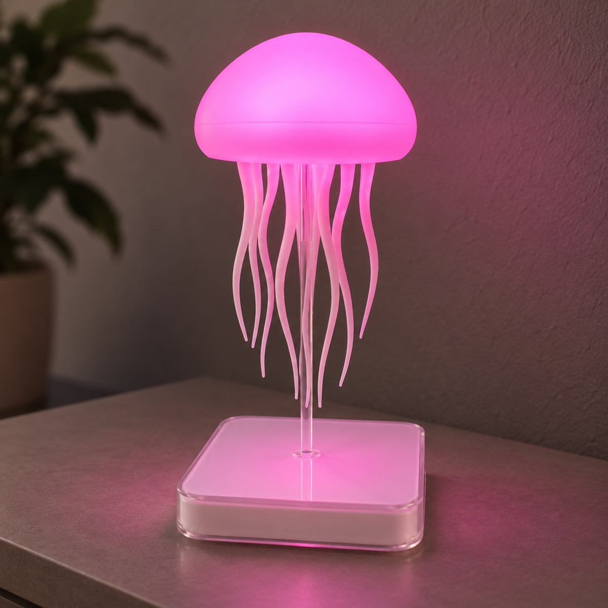 Dancing Jellyfish lamp showing pink illumination on its clear stem and square base